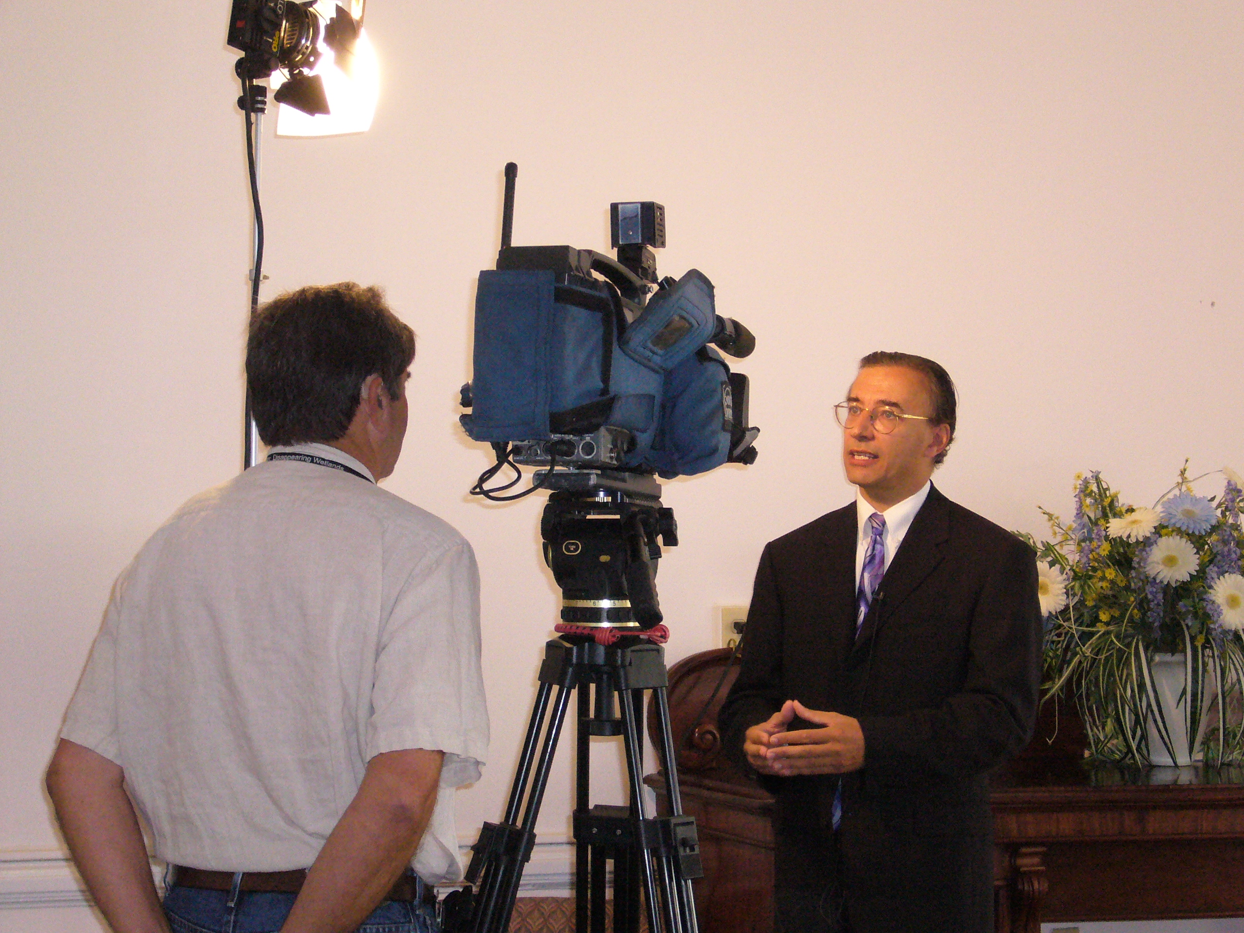Dr. Alain Saint-Saens speaking for an American TV Channel.